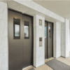 Commercial entryway refaced with 3M DI-NOC ST-1831 Isabelline Marble and CH-1630 Black Zirconium Diagonal
