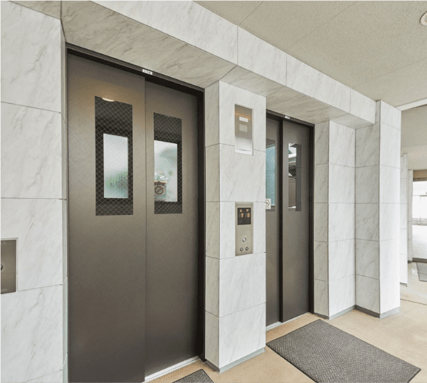 Commercial entryway refaced with 3M DI-NOC ST-1831 Isabelline Marble and CH-1630 Black Zirconium Diagonal